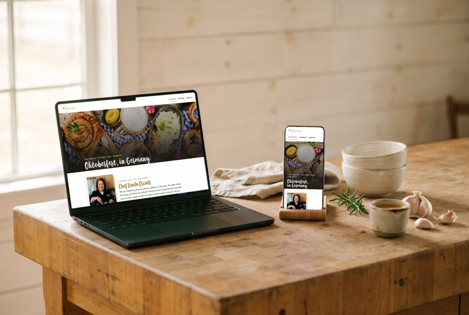 The club's October month open on a laptop and a phone, on a wooden counter at the Barn
